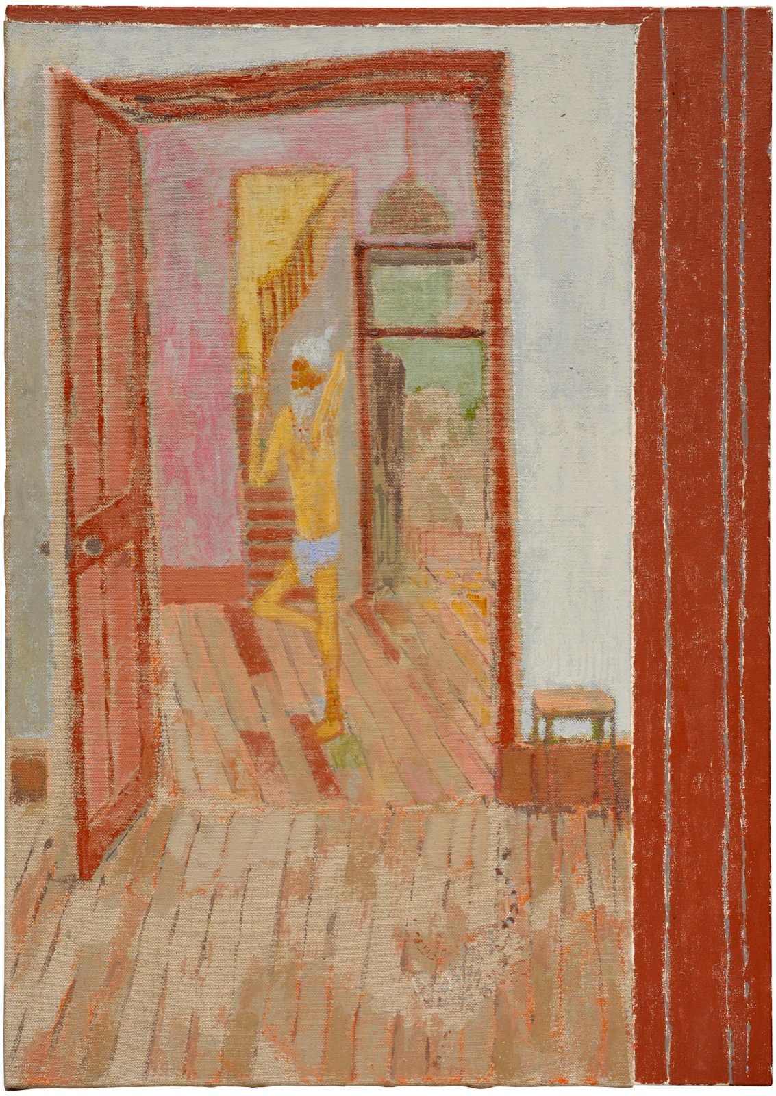 A view through an open red door into a pink room where a bearded figure in shorts balances on one leg, bare floorboards in the foreground and a red striped band down the right edge.