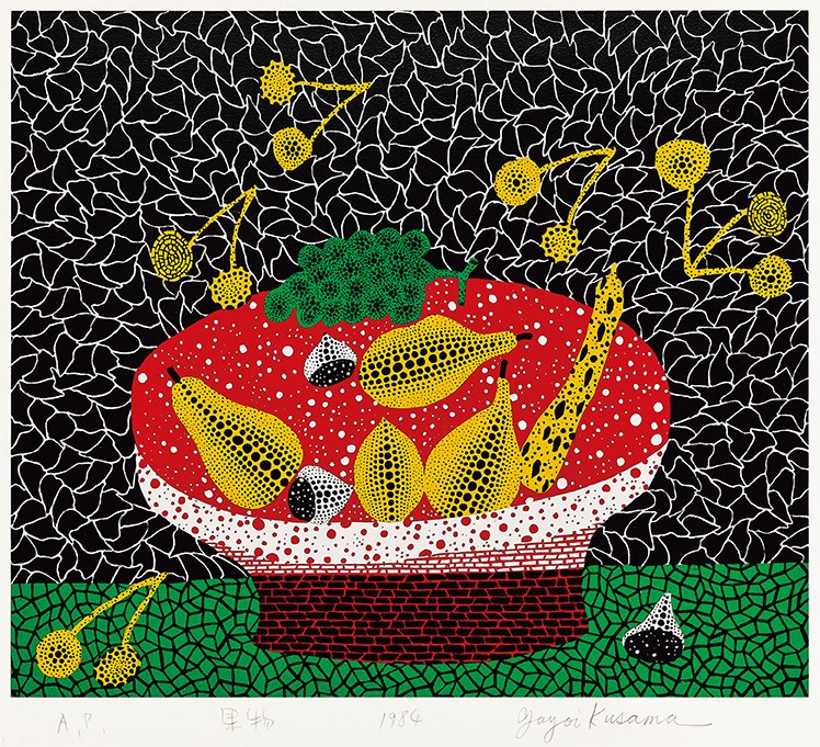 A red bowl of yellow fruit on a black ground covered in a white net pattern, a green table top below, with pencil marks in the white margin under the image.