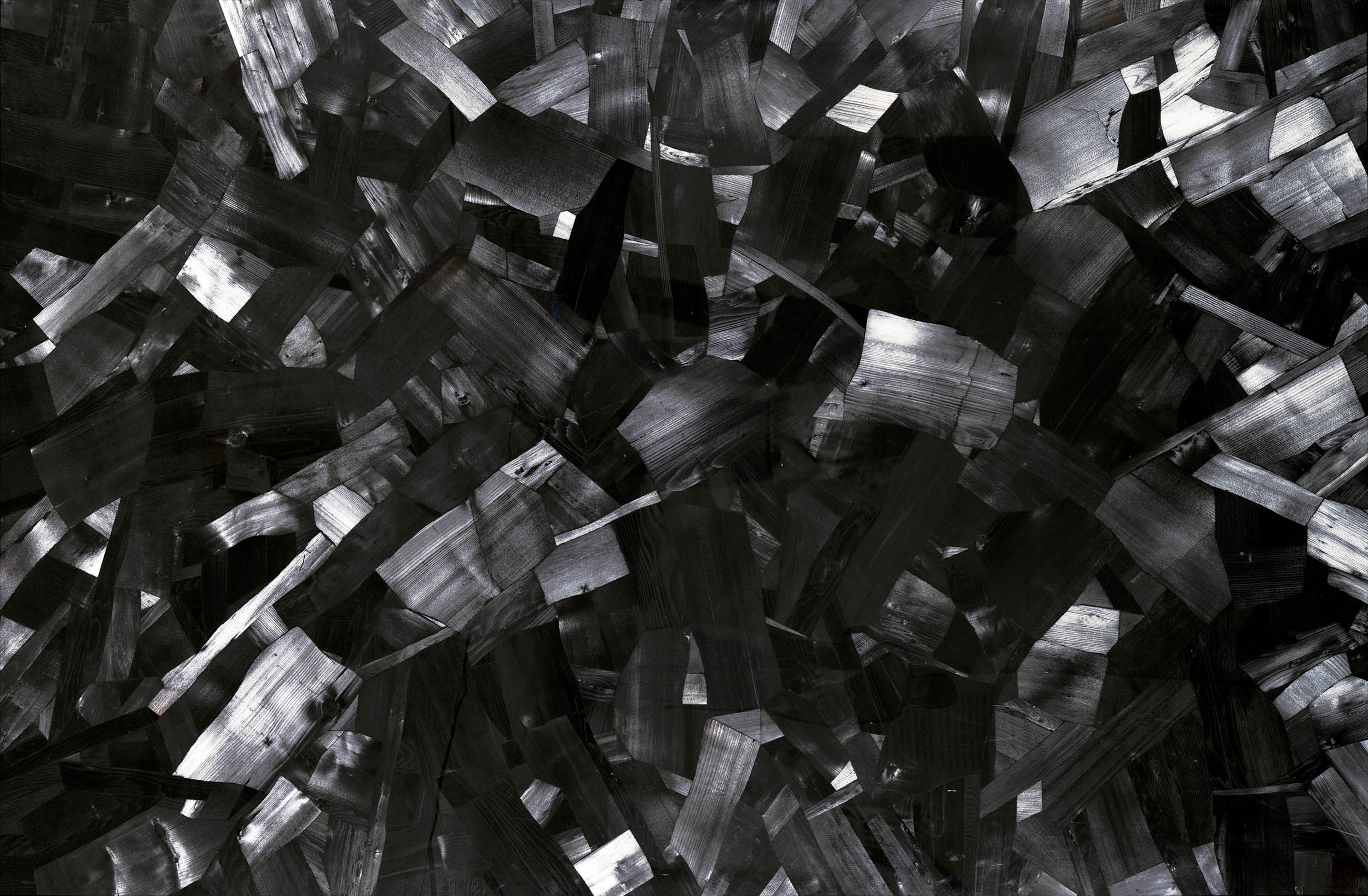 Issu du Feu ch64 by Lee Bae. A wide canvas packed edge to edge with cut charcoal blocks, the surface ground back so the grain and the burn marks read as a dense black field.